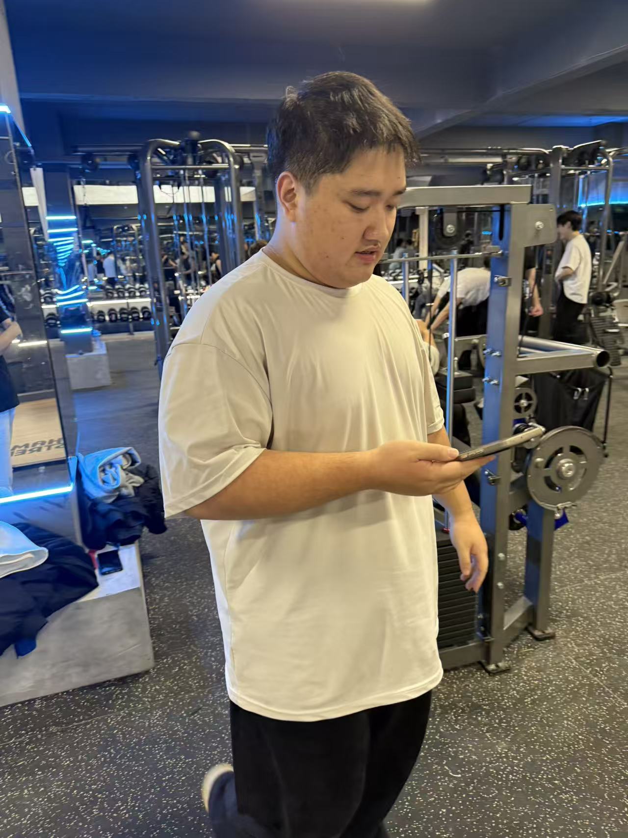 Gym Standing Phone Check White Shirt
